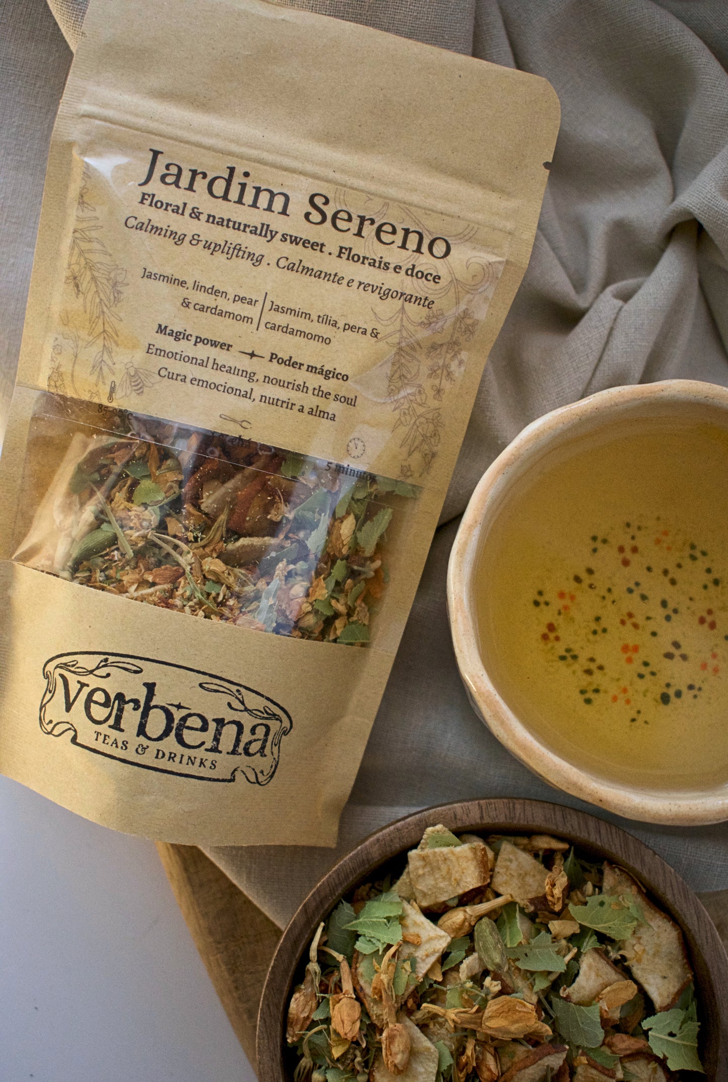 Jardim Sereno tea package with a bowl of tea and a cup of tea on a neutral background