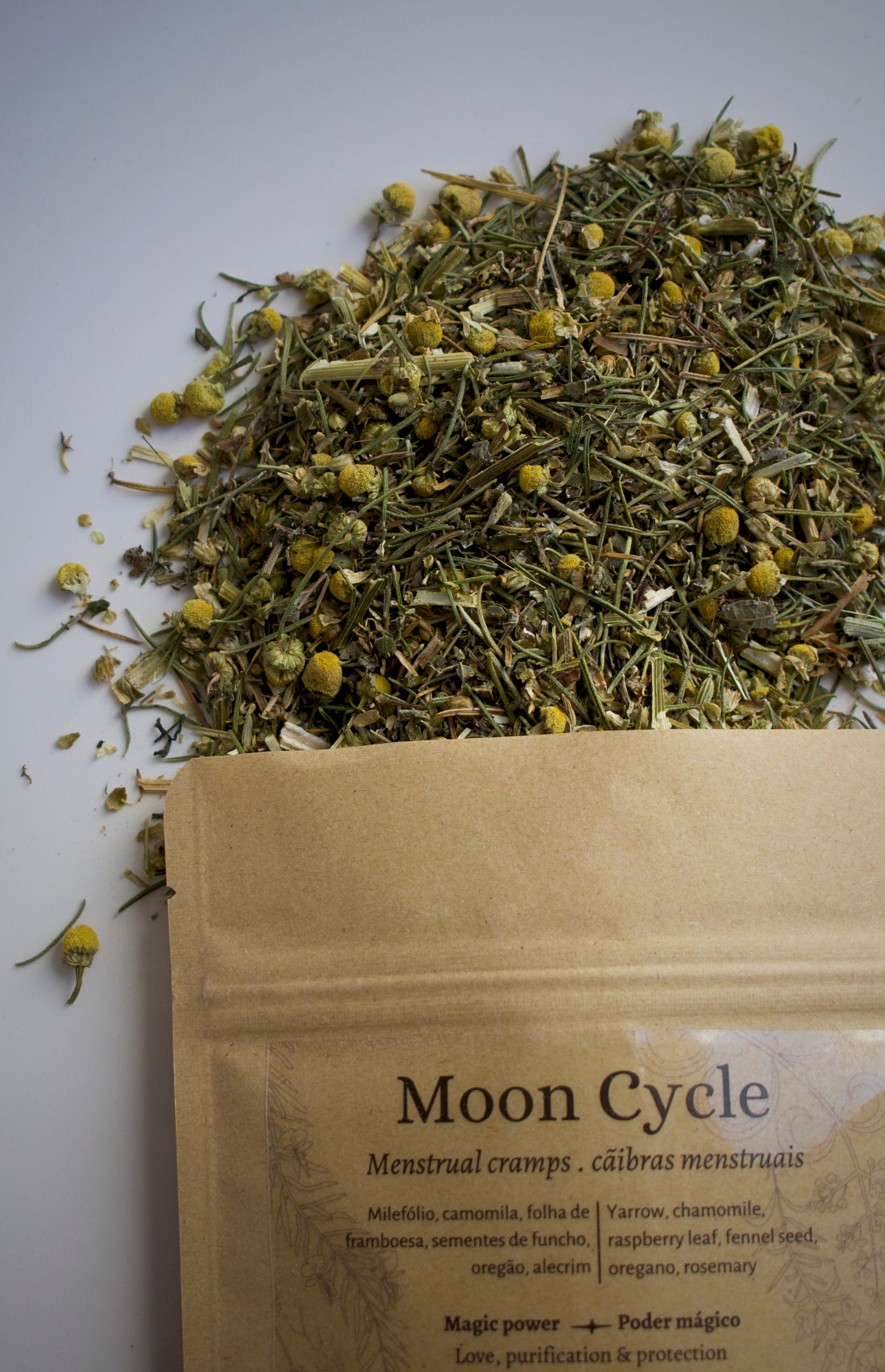 Dried herbs with a 'Moon Cycle' packaging on a light background