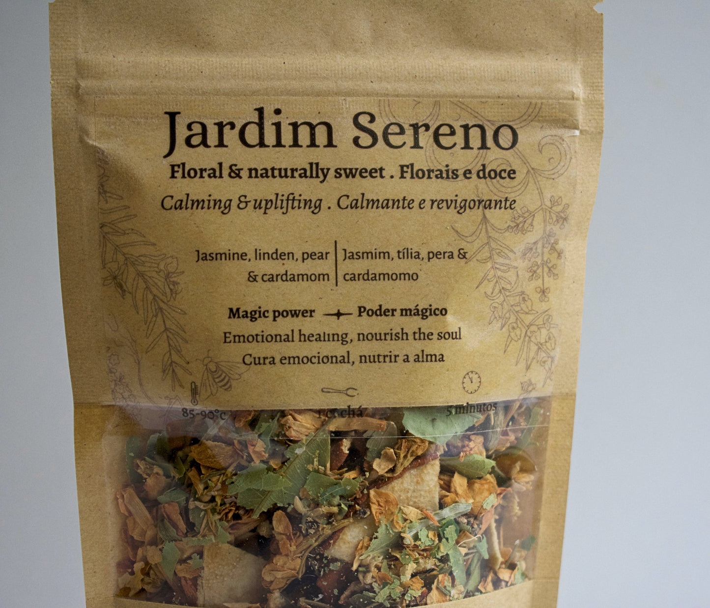 Kraft bag with Jardim Sereno loose leaves tea inside. On the kraft bag a transparent label showing information of the herbal blend.
