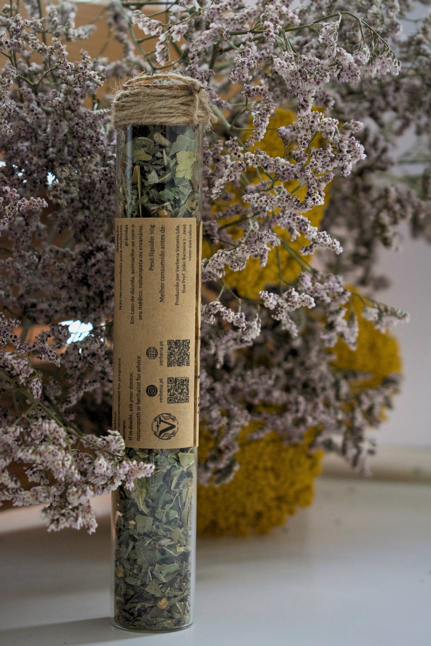 Glass tube with a label "take it easy" against a floral background.
