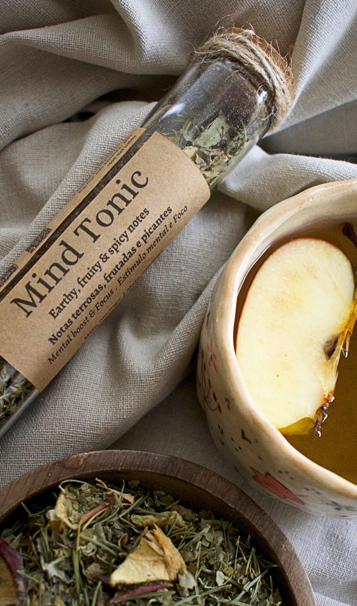 Mind Tonic loose leaves tea in a glass tubes on a piece of linen cloth