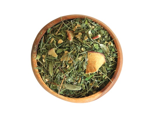 A wooden bowl filled with Mind Tonic loose leaves tea and dried apple.