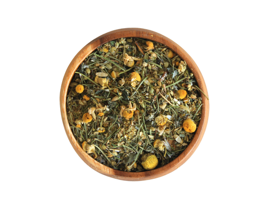 Wooden bowl filled with dried herbs and flowers on a white background